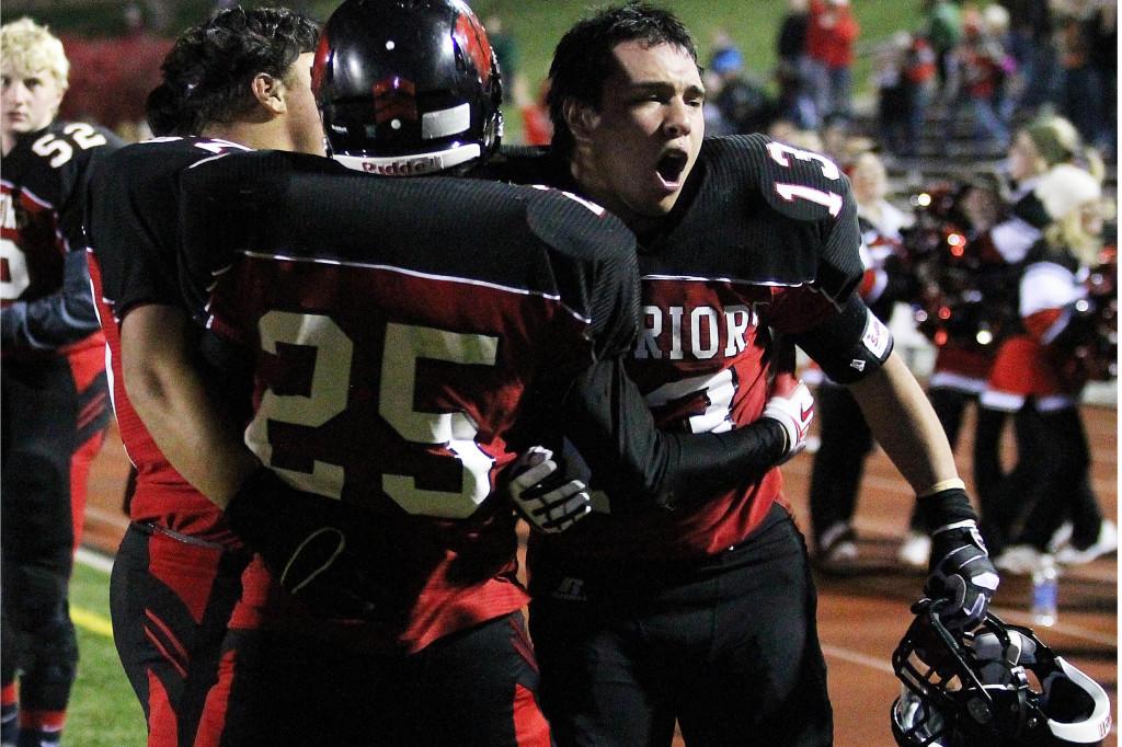 Senior running back Lane Yates celebrates with senior wide receiver and cornerback Jamaal Conway-Smith. Yates and Conway-Smith are both headed to Wayne State for football next year. Photo by Clair Selby