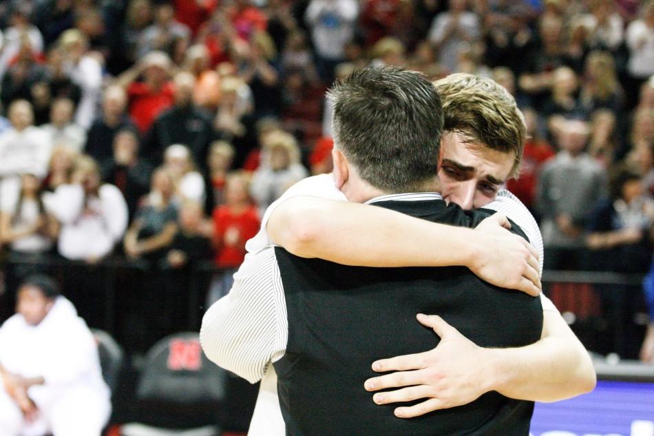 Westside head boys basketball coach Brian Nemecek hugs his son, senior basketball player Brock Nemecek, after presenting him with his state runner-up medal following Westsides 56-50 loss to Bellevue West. Nemecek coached the Warriors to a 21-6 season. Photo by Olivia Beier