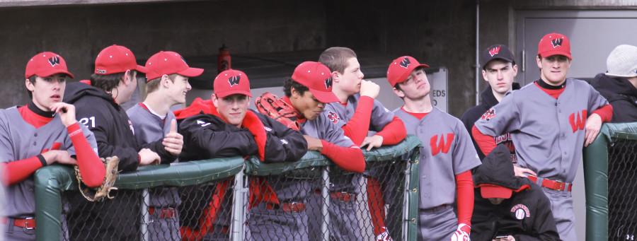 The Warrior baseball team watches their teammates during the Varsity game. 