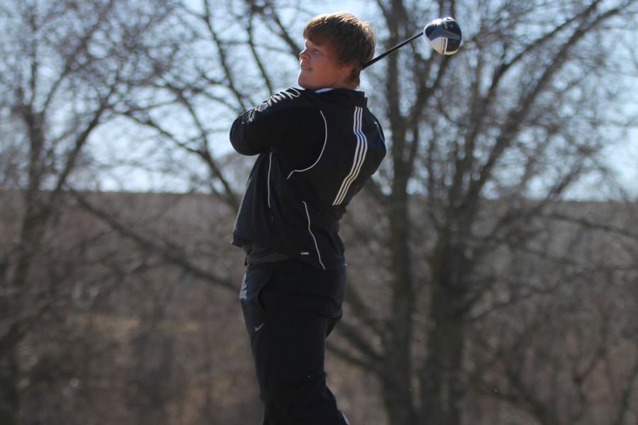 Varsity+golfer+senior+Tom+Stegman+follows+through+on+a+swing+during+a+practice+at+Benson+Golf+Course+April+8.+Stegman+shot+an+80+during+the+district+tournament+at+Highlands+Golf+Course+in+Lincoln.+Photo+by+John+Ficenec+