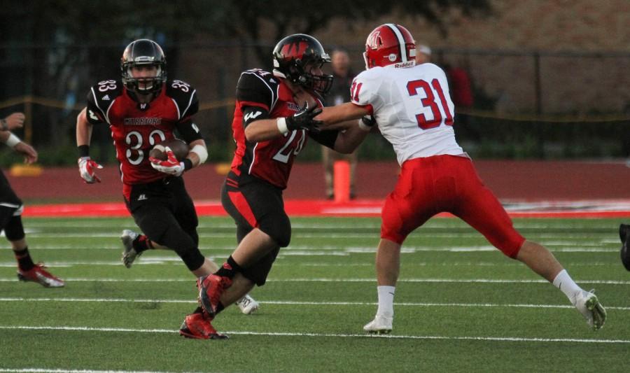 Junior Logan Duryee carries the ball in the first half of Westside's 21-13 victory over Millard South Friday, Sept. 12. Duryee rushed for 91 yards on 20 carries in the game. Photo by Clair Selby