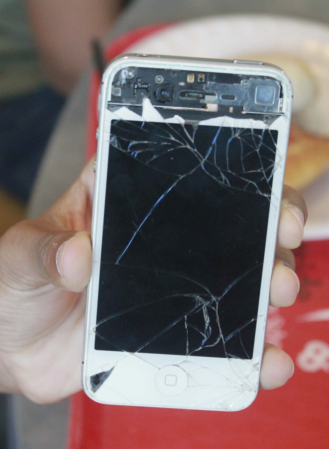 Freshman Elijah Hamilton has a pretty simple story behind his damages. Repeated drops have led to a full face crack, and all the glass off of the top part of the phone is ripped off. Photo by Jack Cohen