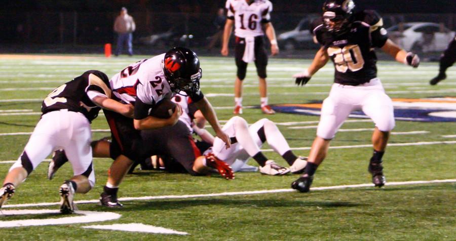 Senior Mitch Schenkelberg lowers his shoulder as a Fremont defender tries to bring him down during Westsides 60-27 victory over Fremont Friday, Oct. 23. Westside faces Millard West at 7:30 p.m. in the opening round of the state tournament. Photo by Clair Selby