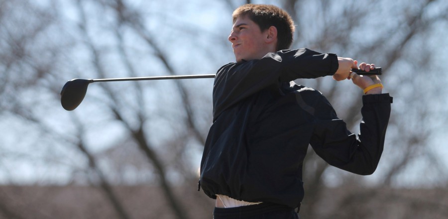 Senior AJ Nolin, one of the golf teams two most experienced returners, follows through on a swing during practice. Nolin played in nine varsity tournaments for the Warriors last season. Photo by John Ficenic