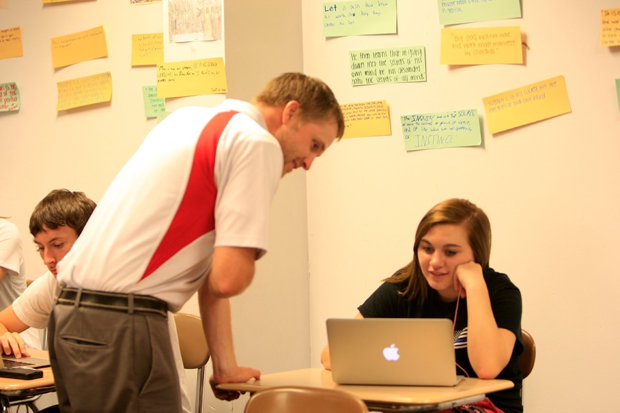 English instructor Matthew Hodgson helps senior student with her english paper. 