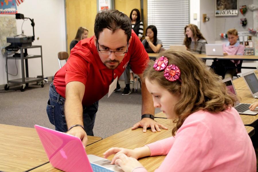 Substitute teacher Kevin Stricklett helps a student while covering for social studies instructor Katherine Lupo. Lupo left for maternity leave earlier this week.