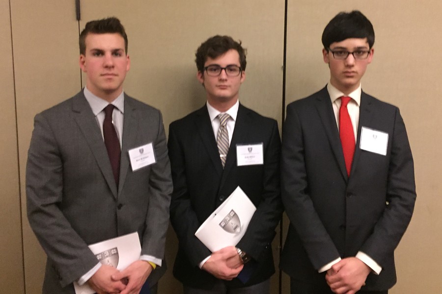 Senior Brett Robinson and juniors Josh Militti and Max Goldberg attend Harvard Model Congress in Boston. The students pose before entering their assigned committees.
