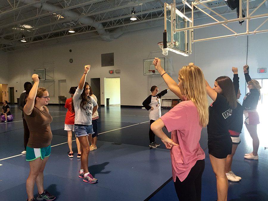Student mentors help with Sparkles cheerleading program