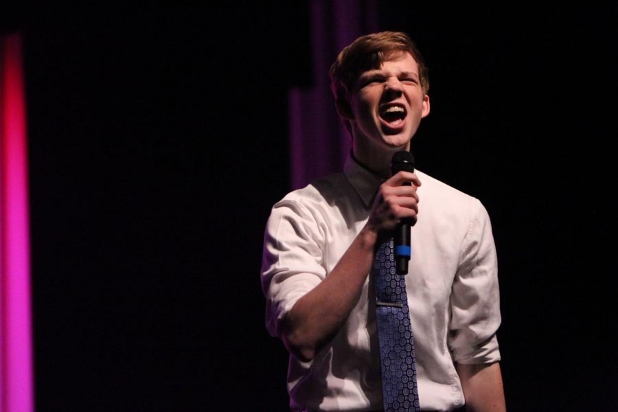 Senior Evan Dondlinger does standup comedy for the talent round. 