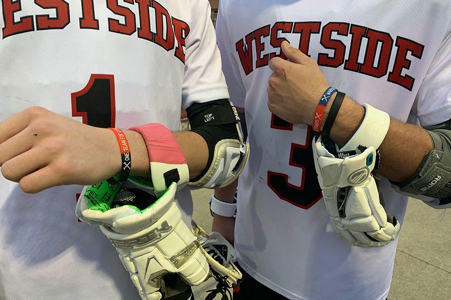 Freshmen+Ethan+Newmyer+and+Carter+Hogan+wore+the+One+Team+for+Others+wristband+during+their+game+last+Sunday.
