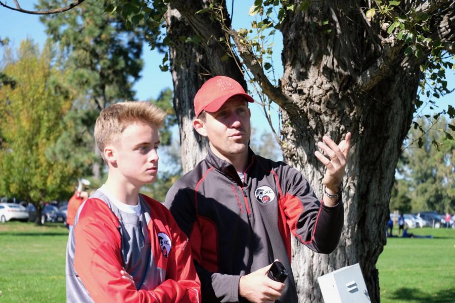 Junior Jacob Caffey discusses with boys head coach Andrew Easton.