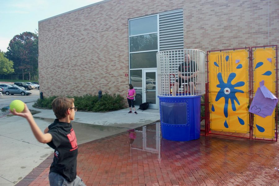 Eighth grader from Westside Middle School attempts to dunk Superintendent Mike Lucas. 