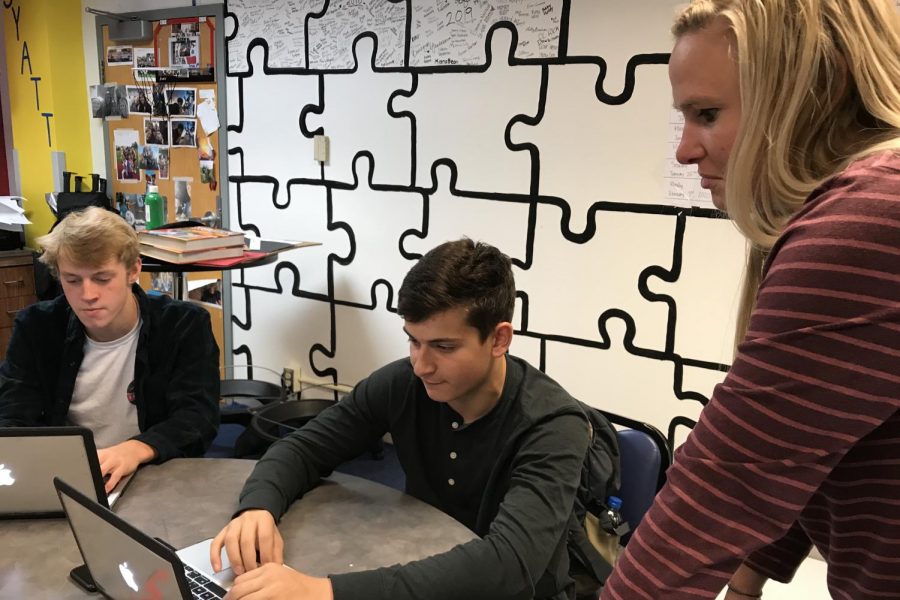 Marketing+2+students%2C+seniors+Spencer+Schneiderman+and+Jackson+Rall%2C+discuss+their+project+with+Marketing+2+instructor+Kalen+Carlson.