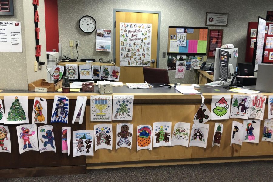 Educational Assistant Michelle Hinde showcases the students artwork at her desk in the Math IMC.