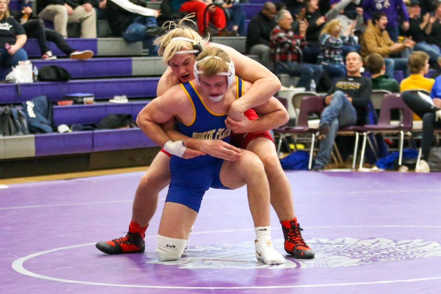 Fifth-ranked sophomore Cole Haberman wrestles against second-ranked junior Gavin Brauer from North Platte High School during the Bellevue East Duals Tournament.  