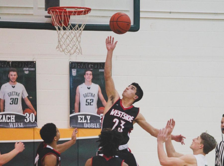 Westside sophomore Dominic Rezac goes to the hoop in a game against Gretna.