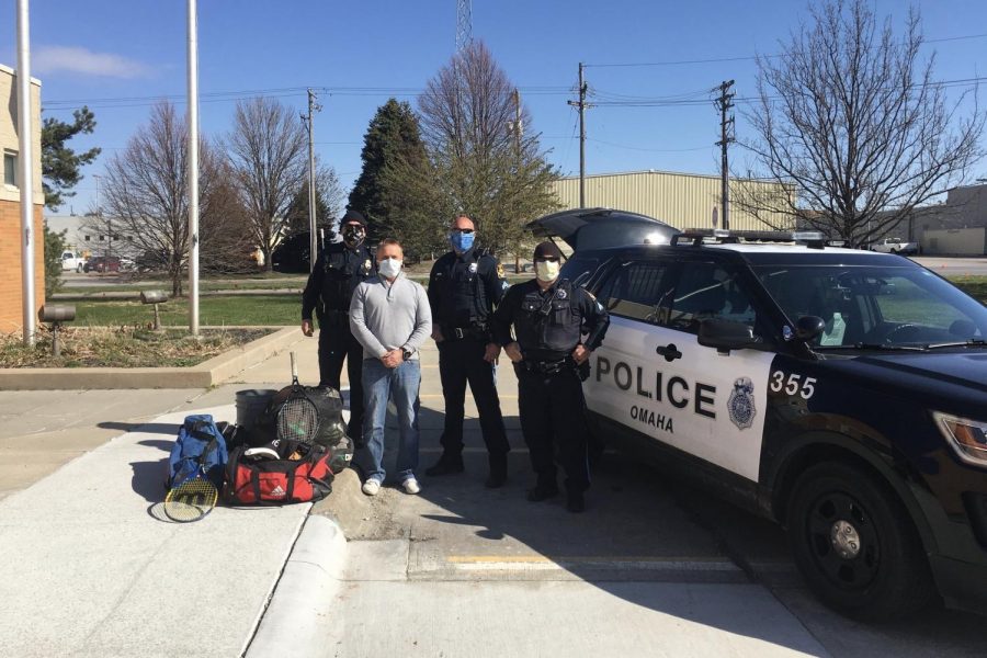 Westside Board of Education Candidate John Brian alongside Omaha Police Officers display the sporting good items collected and donated to Omaha Police Departments PACE organization.