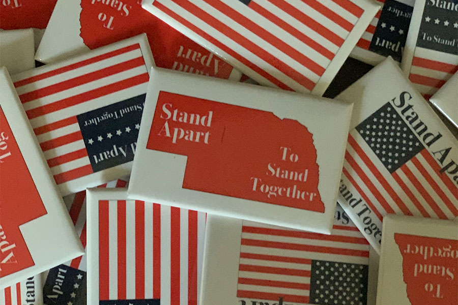 Westside sophomore Luke Steiner recently created  buttons labeled Stand Apart to Stand Together to promote social distancing.