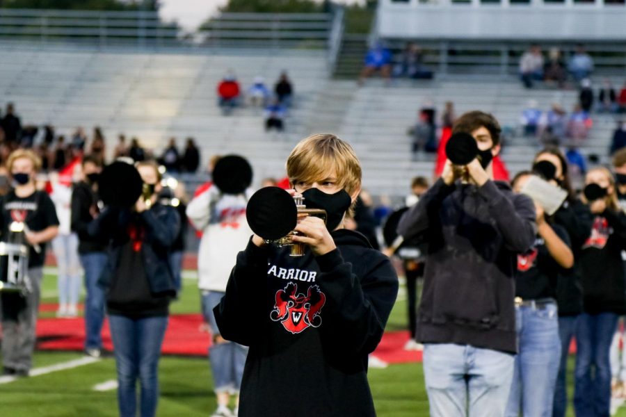 Westside marching band performs through specialized masks and bell-covers during the homecoming football game.