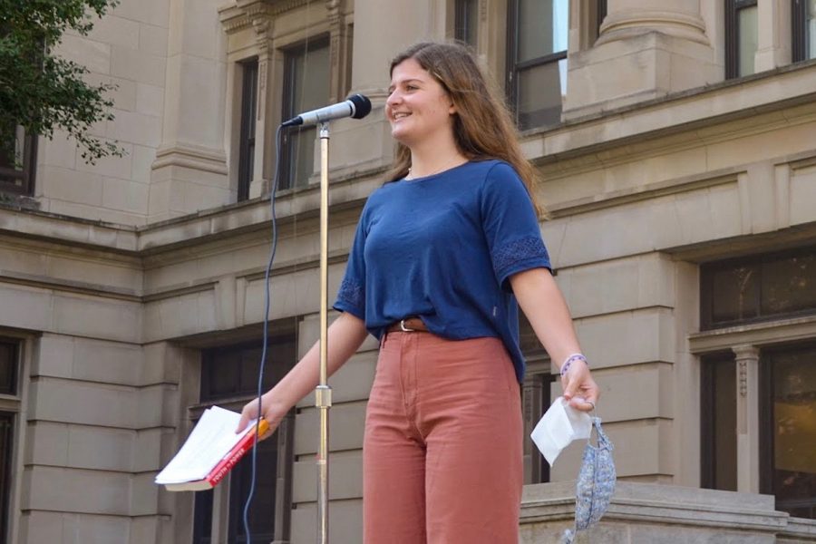 Senior Camille Beaulieu speaks in front of the Douglas County Courthouse during a strike for climate justice on Sept. 25.