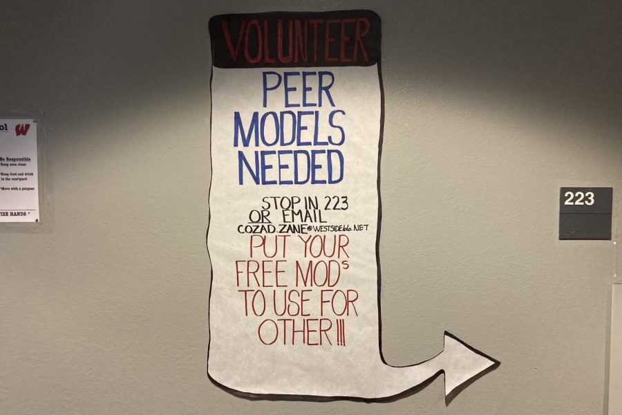 A Peer Models poster outside of Room 223, the assisted learning classroom.