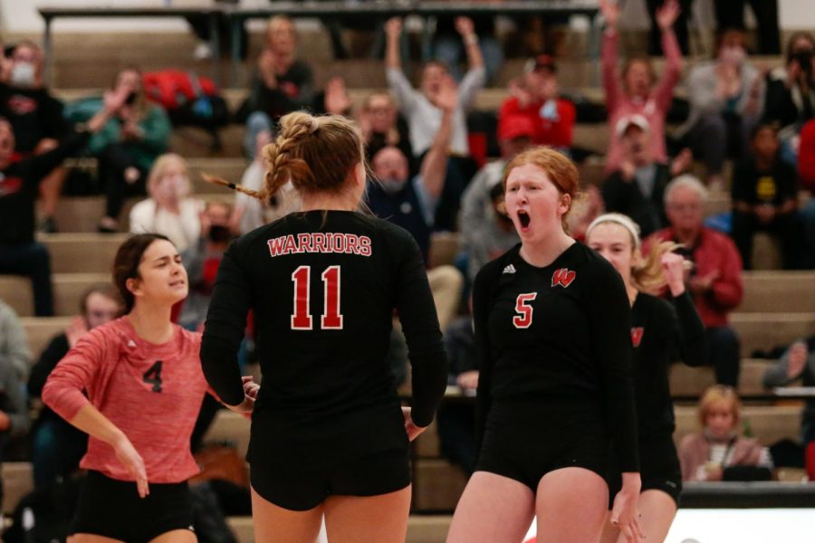 Madilyn Siebler (left) and Isabella Lamb (right) celebrate a point after a dominant block from lamb
