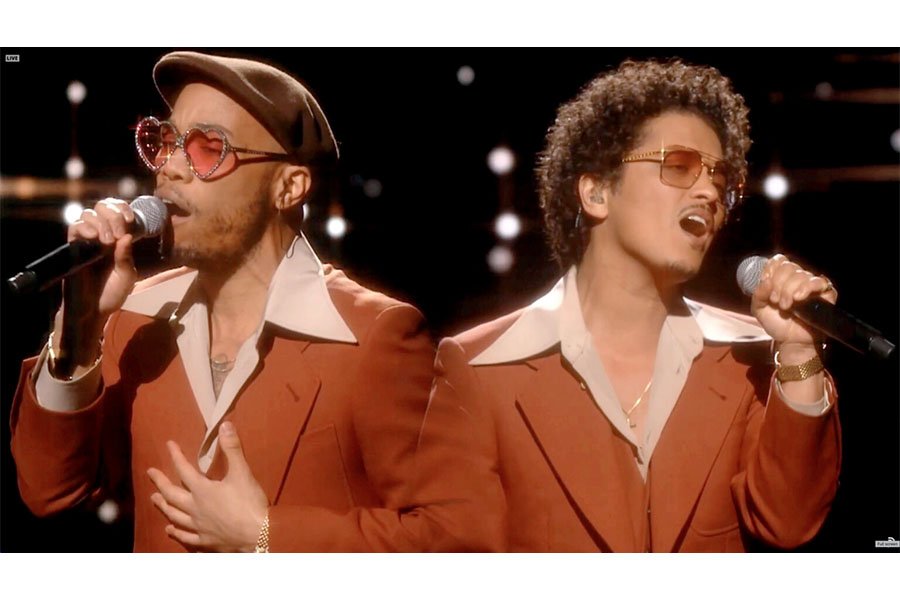Anderson .Paak and Bruno Mars perform at a live concert.