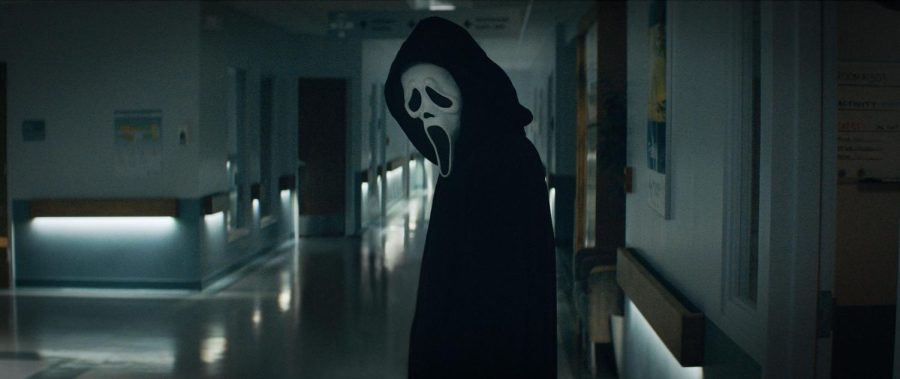 Ghostface standing over his victim in the Woodsboro hospital.