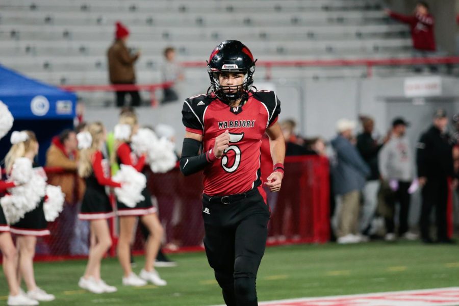 Westside sophomore quarterback Anthony Rezac runs onto the field prior to the 2021 Class A State Championship Game - Photo by Mary Nilius