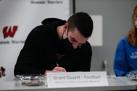 Westside football’s wide receiver Grant Guyett signs his letter of intent to Minnesota State-Mankato to continue his academic and athletic career - Photo by Cece Gerard
