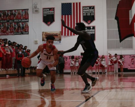 Senior guard Reggie Thomas drives in the right lane in Westside’s 73-69 win over Omaha Central. The Warriors will take on Columbus tonight