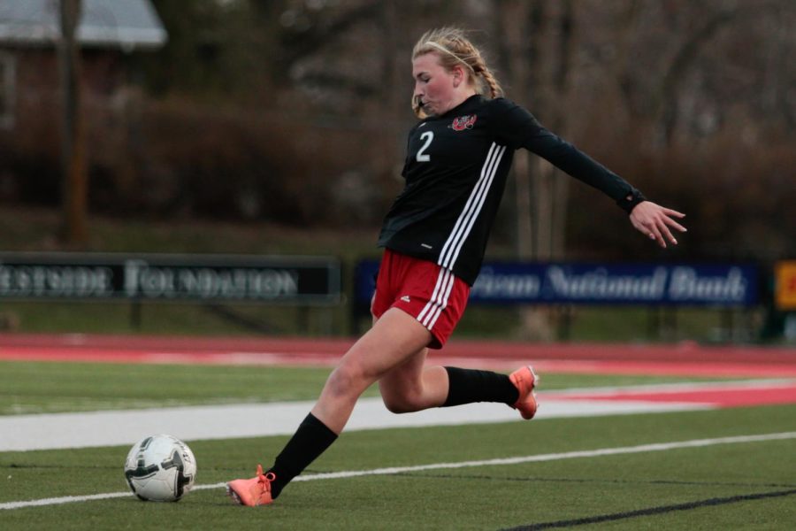 Then junior Elle Hoffman booths the ball into play in Westside’s 2-1 win over Millard North on Mar. 30, 2021