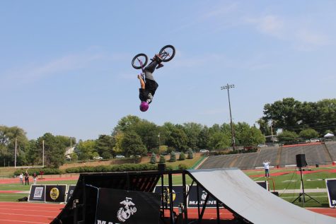 Rider Sam Brussell performed a stunt on his bike in front of students during the program.
