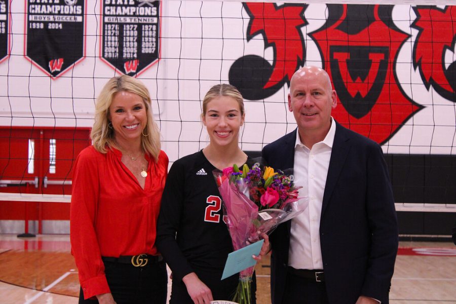Samantha Laird is honored at senior night with her parents.