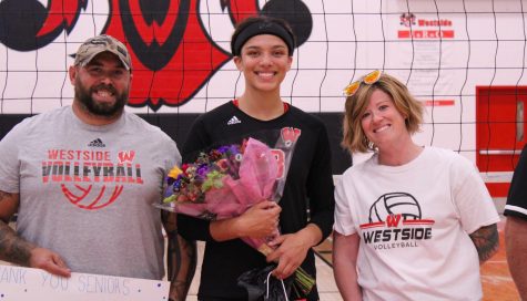 Destiny Ndam-Simpson is celebrated during senior night with her parents.