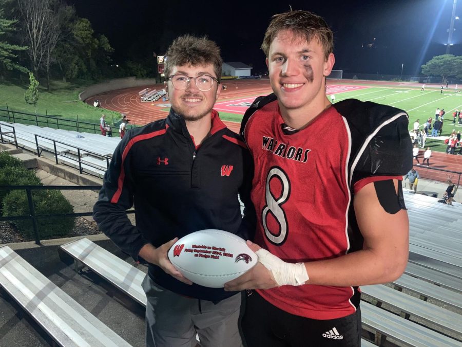 Christian Jones poses with reporter Max Coughlin and the game ball.