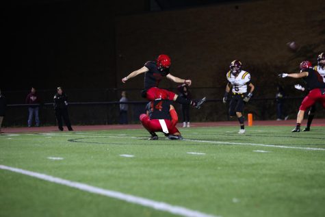 Senior Marty Mormino holds the ball for one of Tristan Alvanos field goal kicks during the 2022 season.