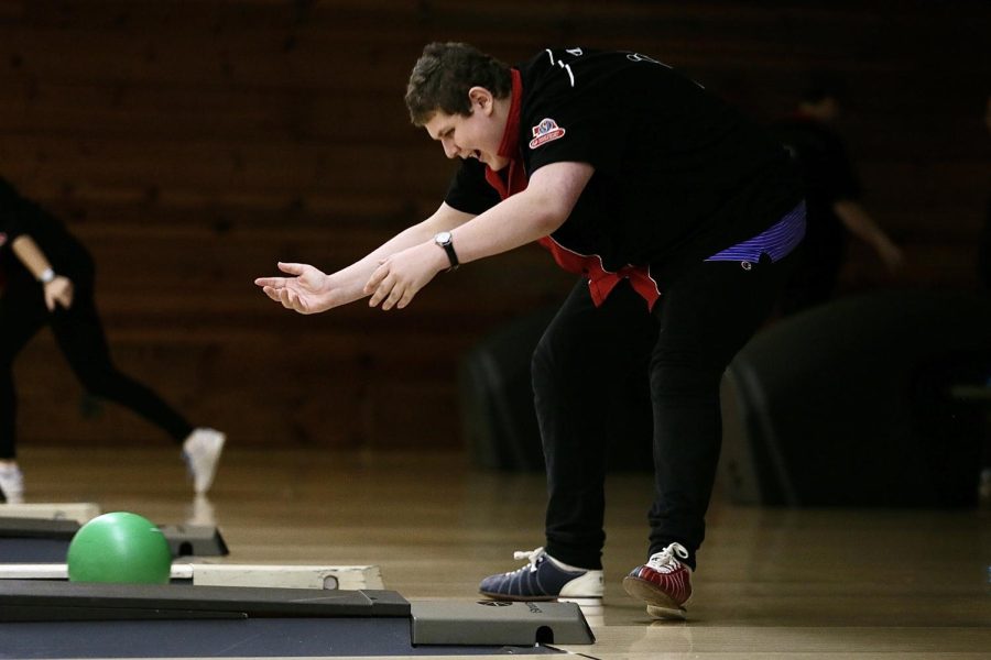Steven David excitedly throws his ball at Chop’s Bowling Alley during a match.