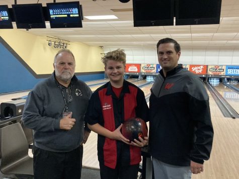 Sophomore Zachary Kastrick poses with his coaches, John Hanssen and John McDonald, after bowling a 244.