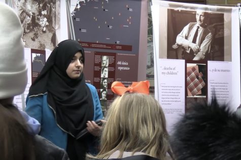 Junior Hafsa Mohammed guides a group through the Anne Frank Traveling Exhibit.