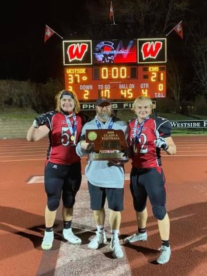Haberman poses with his sons Cole and Cade and the 2020 state championship trophy.
