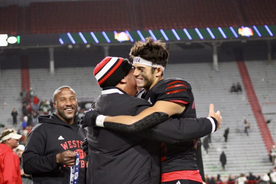 Rezac and Limongi share an embrace after Westside wins the state football championship on November 21, 2022. 