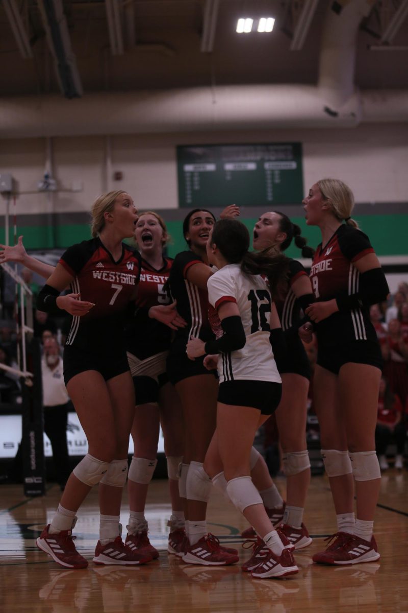 #7 Ashlyn Paymal celebrates a point against Skutt with her teammates.