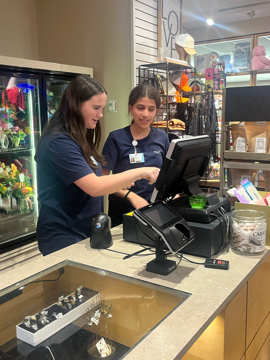 Rhyner works with another volunteer in the gift shop at Bergan Mercy Hospital.  The gift shop is one of many areas she volunteers in.