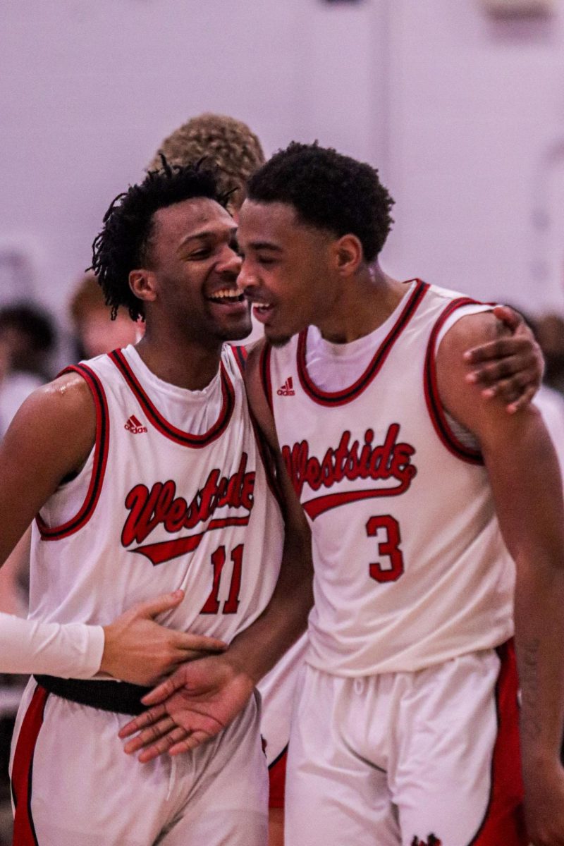 Seniors Ashton Metoyer and Kevin Stubblefield celebrate after the 74-70 overtime win against Creighton Prep.